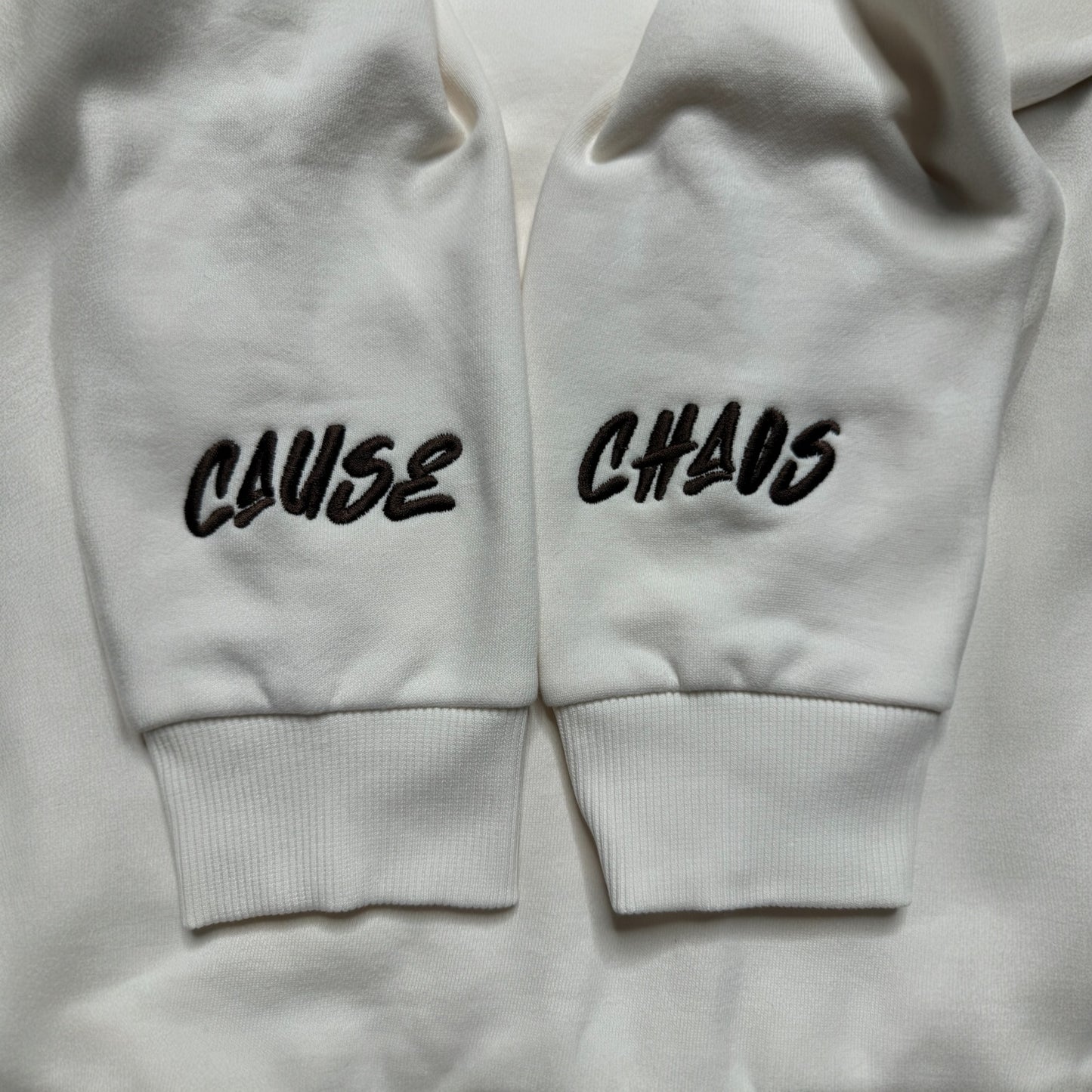 IT’S WHAT WE DO! OFF WHITE PUFF HOODIE - Logo View - Flat Lay 1